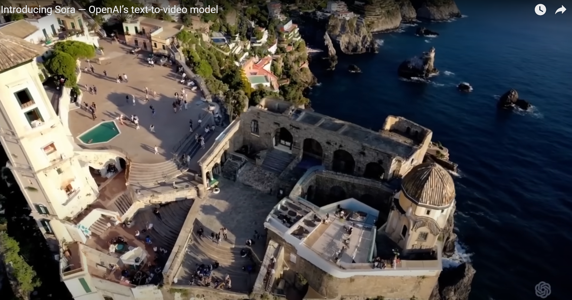 An AI-generated video still from SORA by OpenAI, capturing an aerial view of a coastal town with historic architecture, overlooking the ocean, illustrating the model's capability to create intricate and vibrant scenes.